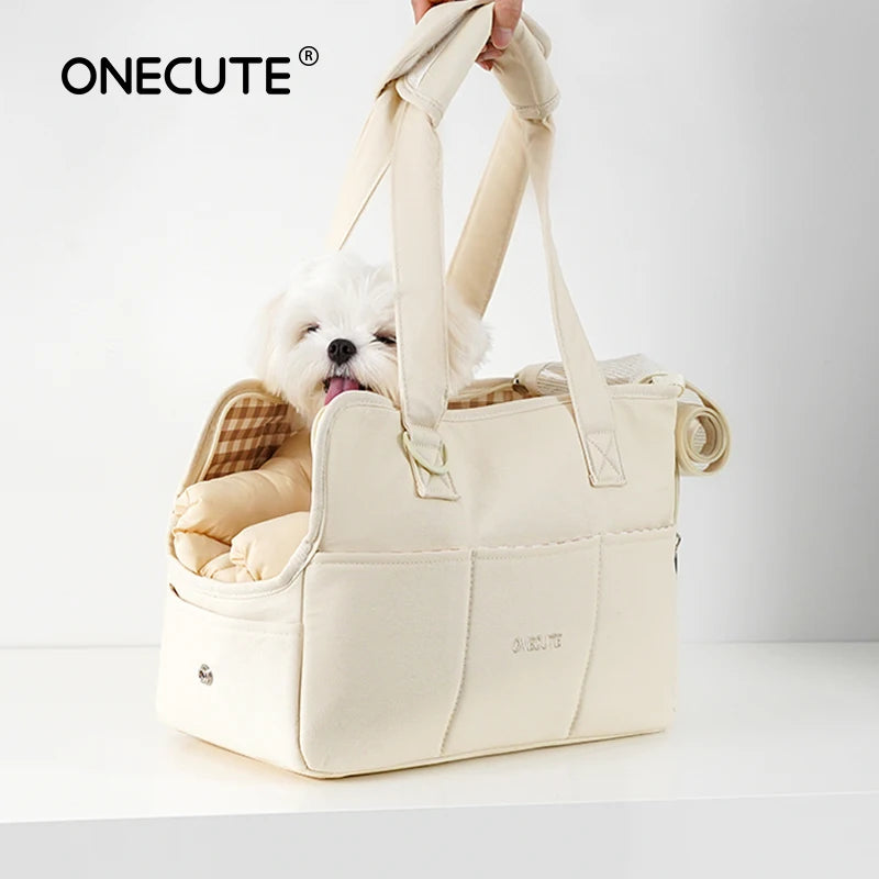 Light beige portable dog carrier handbag with a cute Maltese puppy peeking out, ideal for small dogs like Chihuahuas, perfect for travel and daily outings.